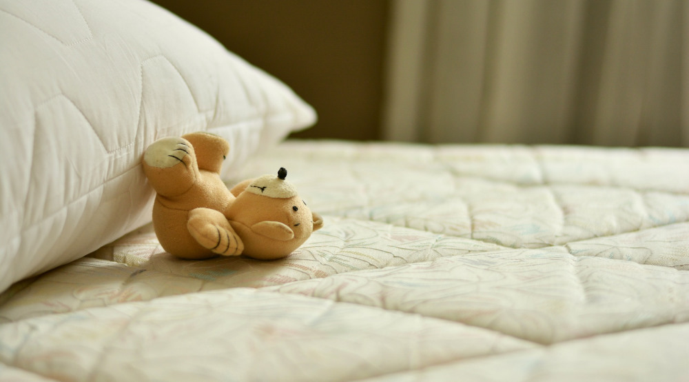 stuffed bear on bed