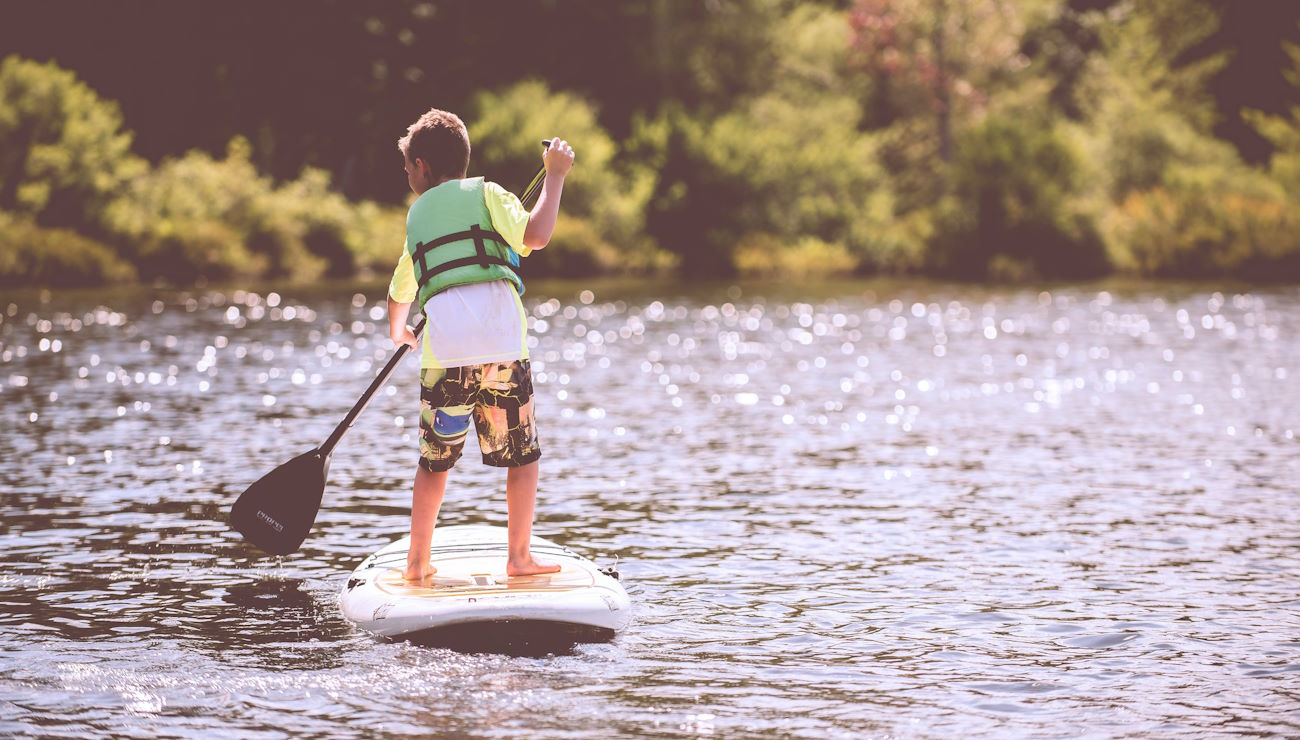 kid on a standup paddleboard