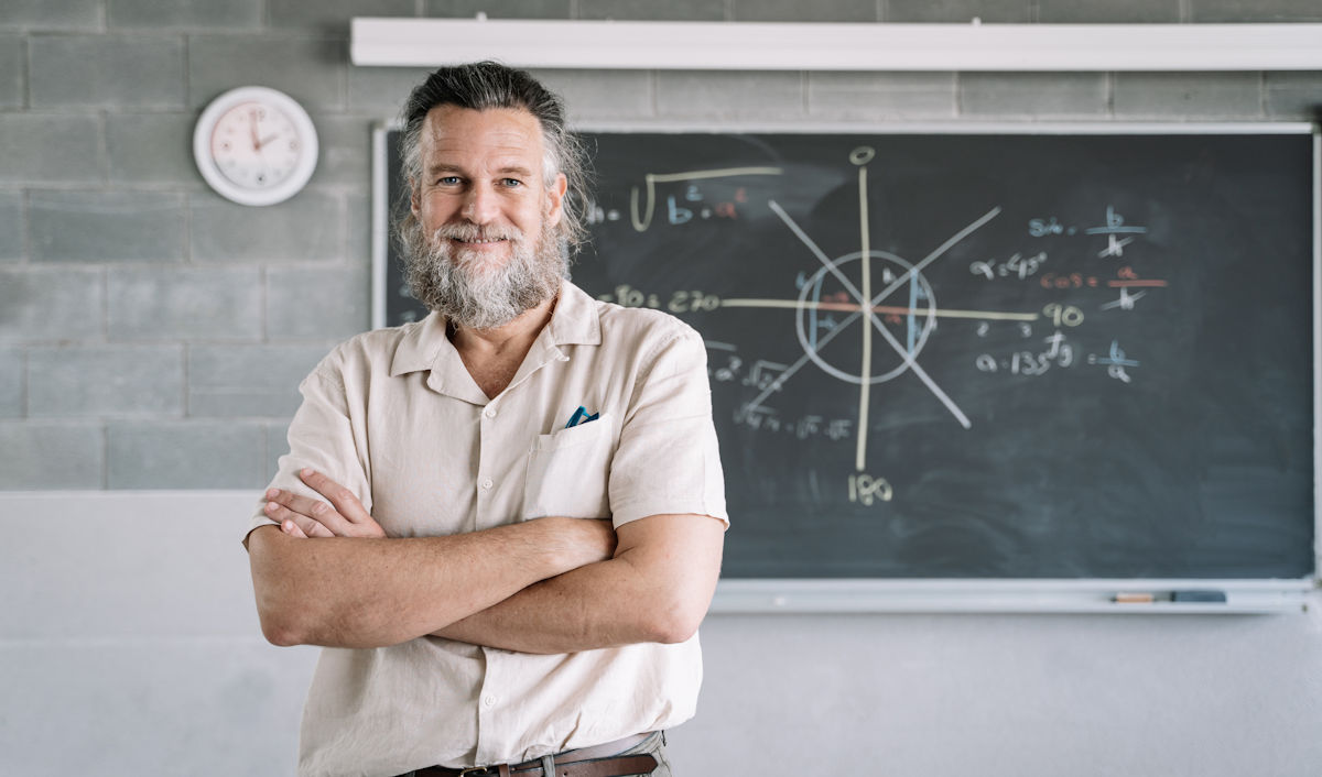 professor in front of chalkboard 